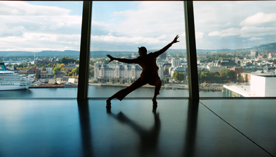 a person standing in front of a window with a view of a city