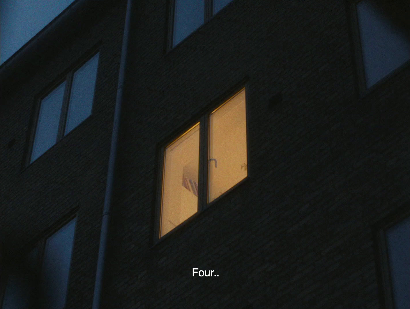 a bird is sitting in the window of a building