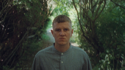 a man standing in the middle of a forest