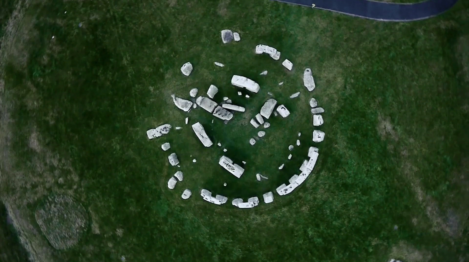 an aerial view of a group of boats in a grassy area