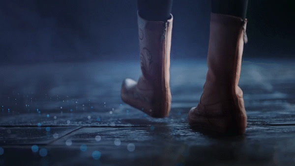 a close up of a person's feet in rain boots