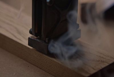 a close up of a piece of wood with smoke coming out of it