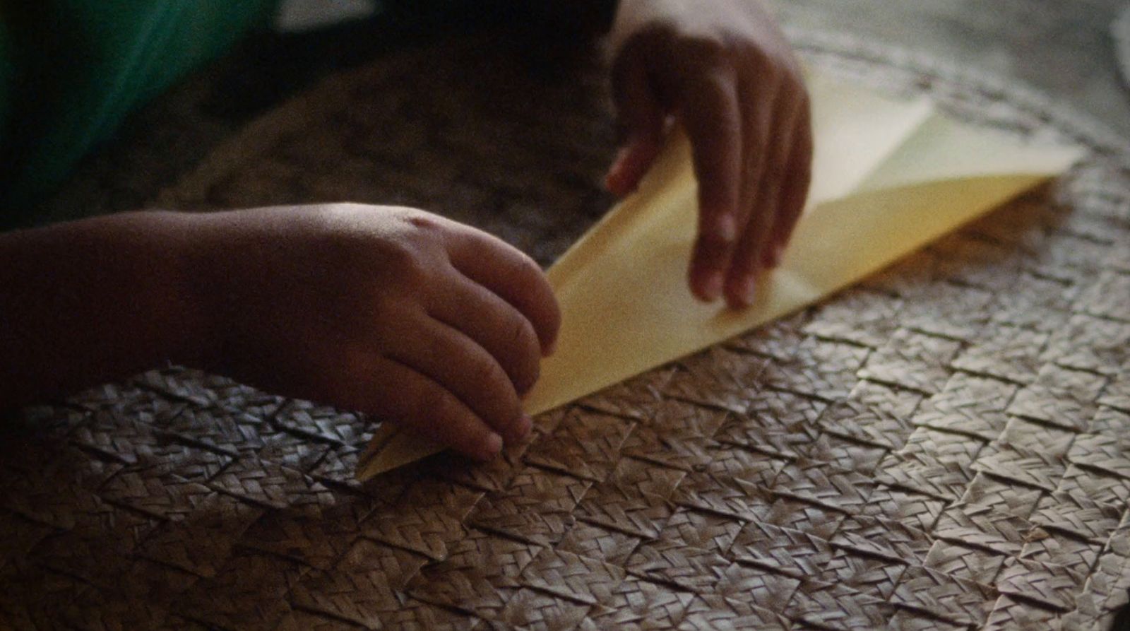 a person is making a piece of paper on a table