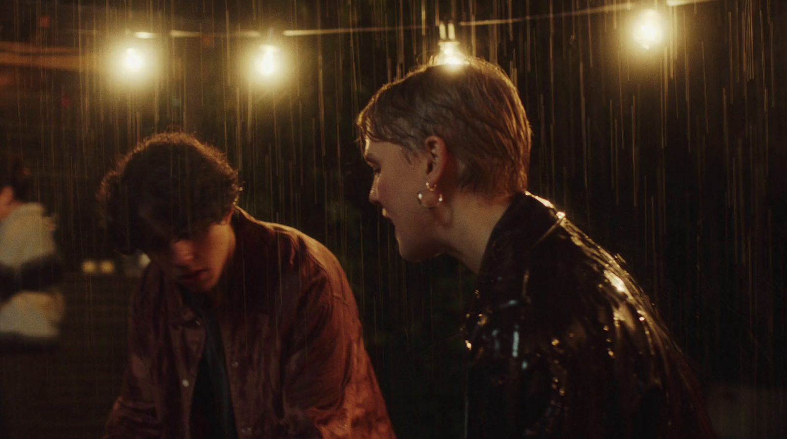 a couple of people that are standing in the rain