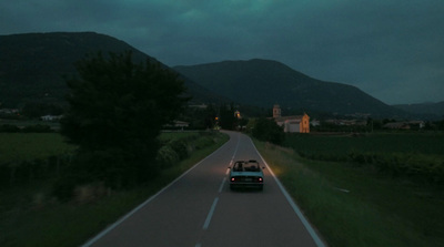 a car driving down a road at night