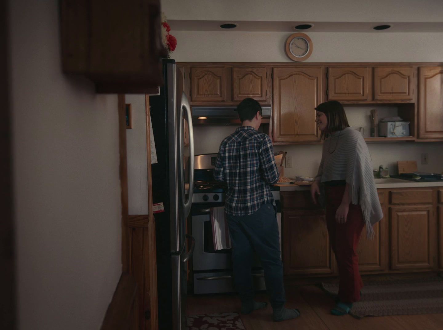 a man and a woman standing in a kitchen