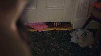 a person standing in front of a door with their hands on the floor