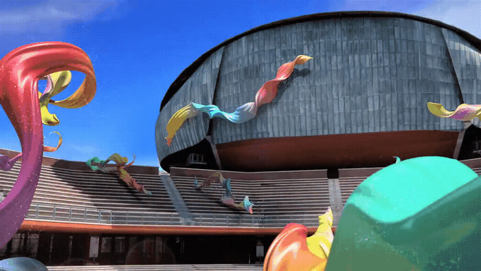 a large building with a bunch of colorful objects in front of it