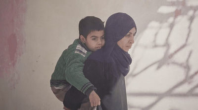 a woman and a boy standing next to each other