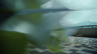 a couple of chairs sitting on top of a tiled floor