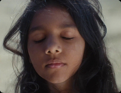 a close up of a young girl with her eyes closed