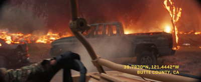 a man laying on a bench in front of a fire