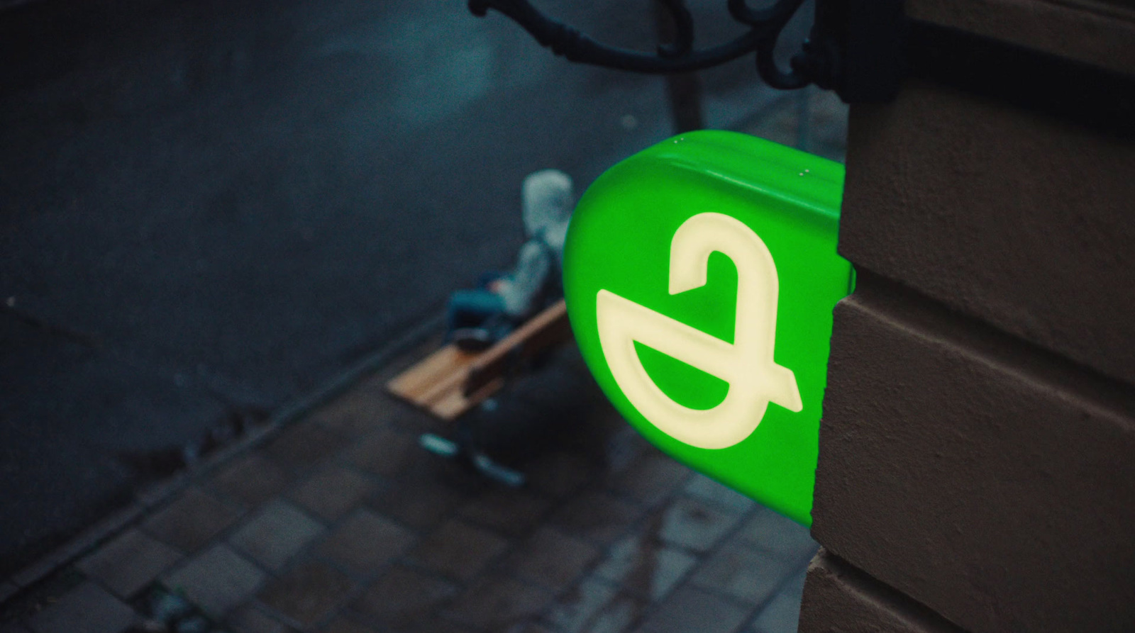 a close up of a green sign on a building