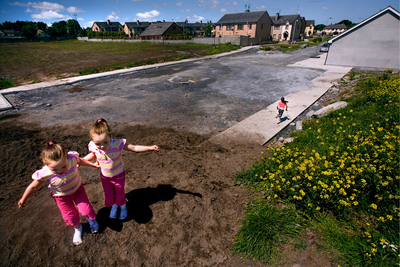 two little girls are playing in the dirt