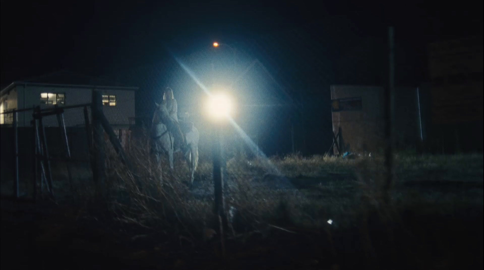 a person riding a horse at night in the dark