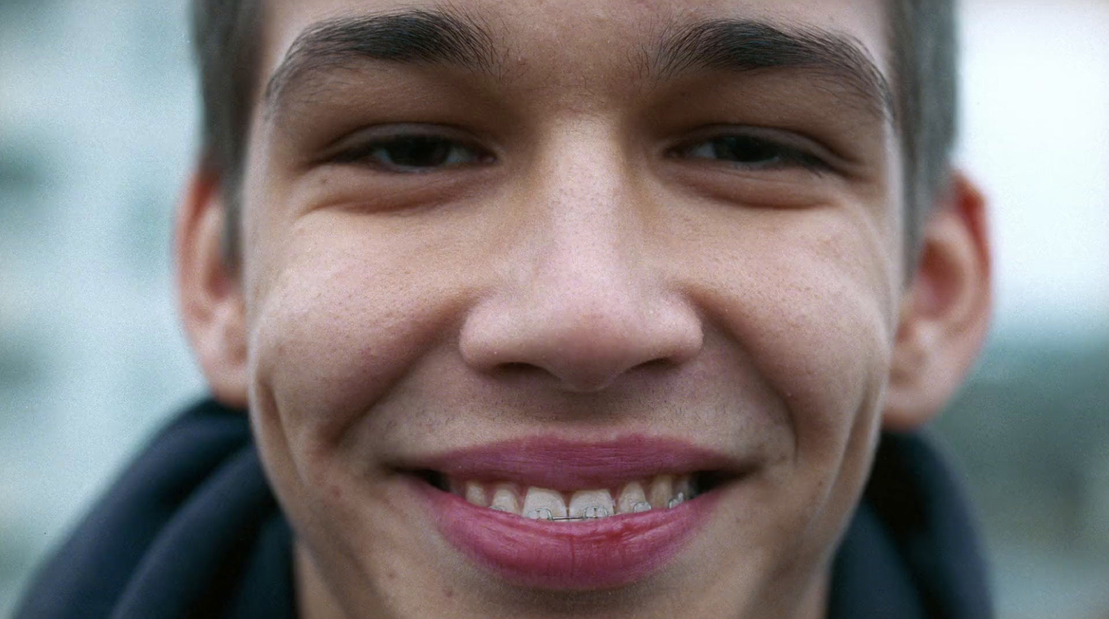 a close up of a person with a tooth brush in his mouth