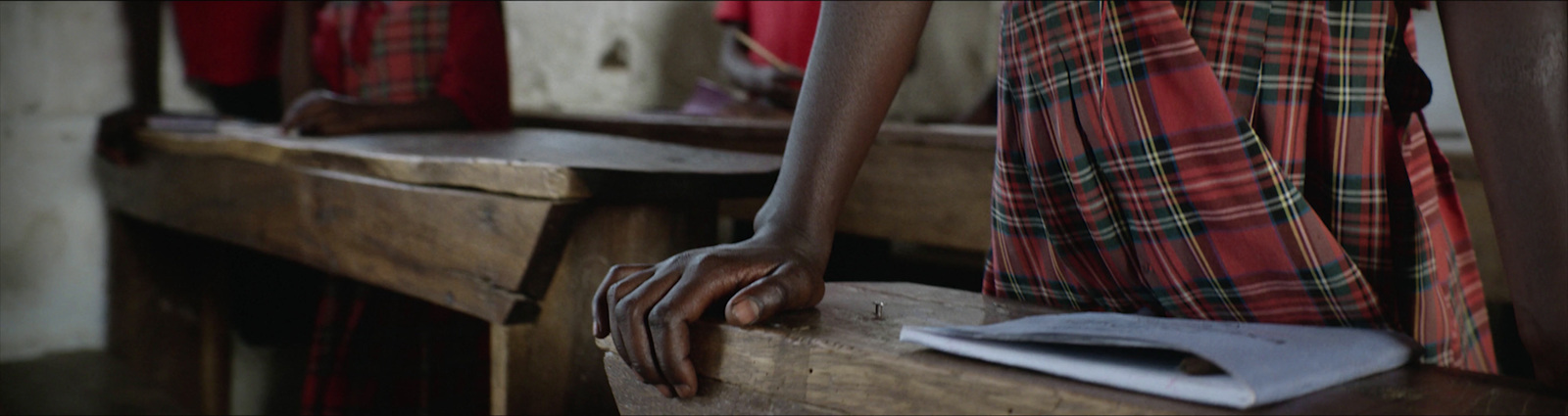 a person with their hand on a wooden bench