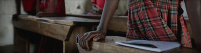 a person with their hand on a wooden bench