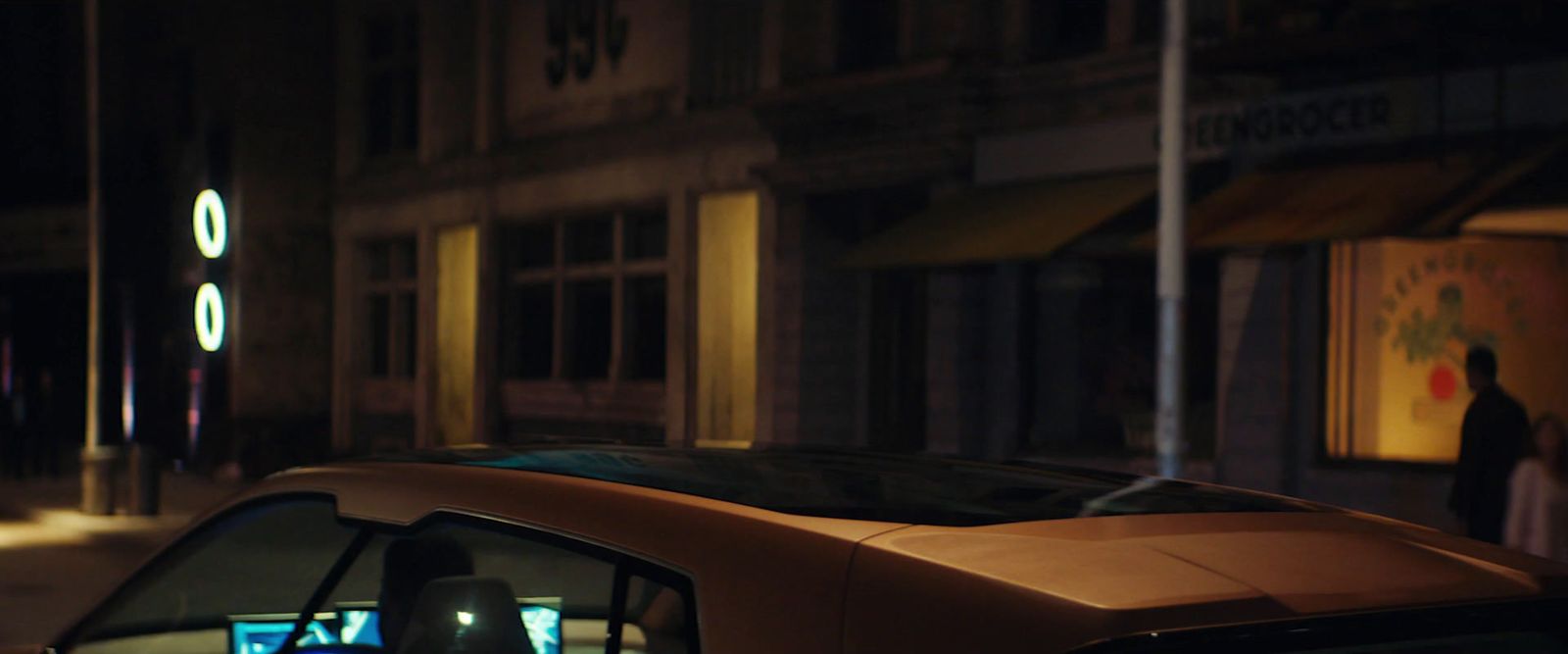 a car parked on the side of a street at night