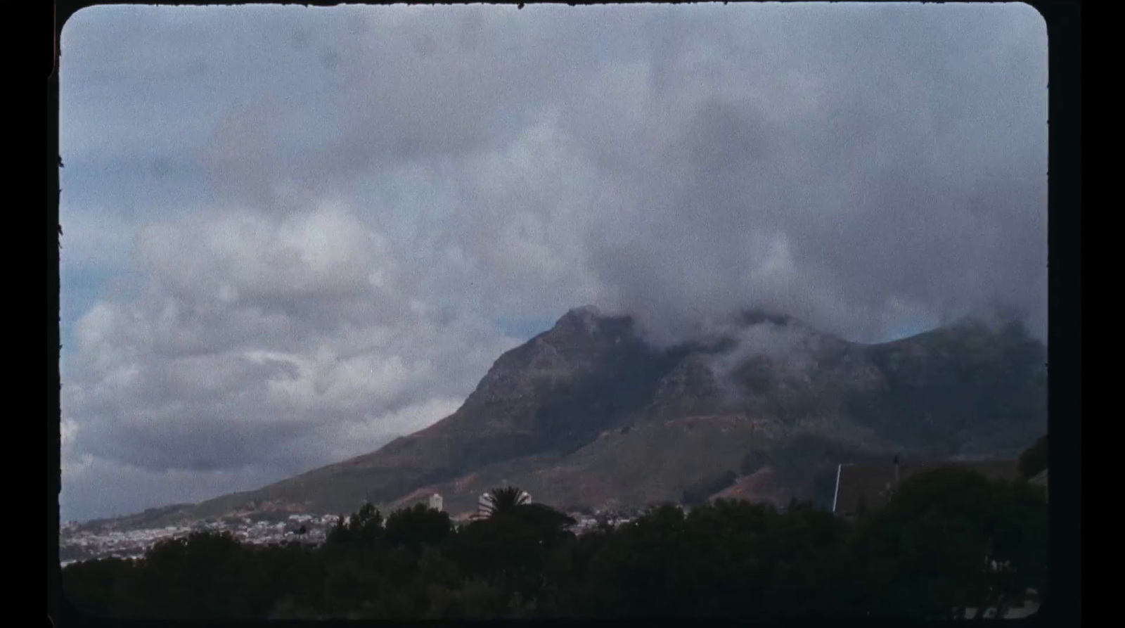 a view of a mountain with clouds in the sky