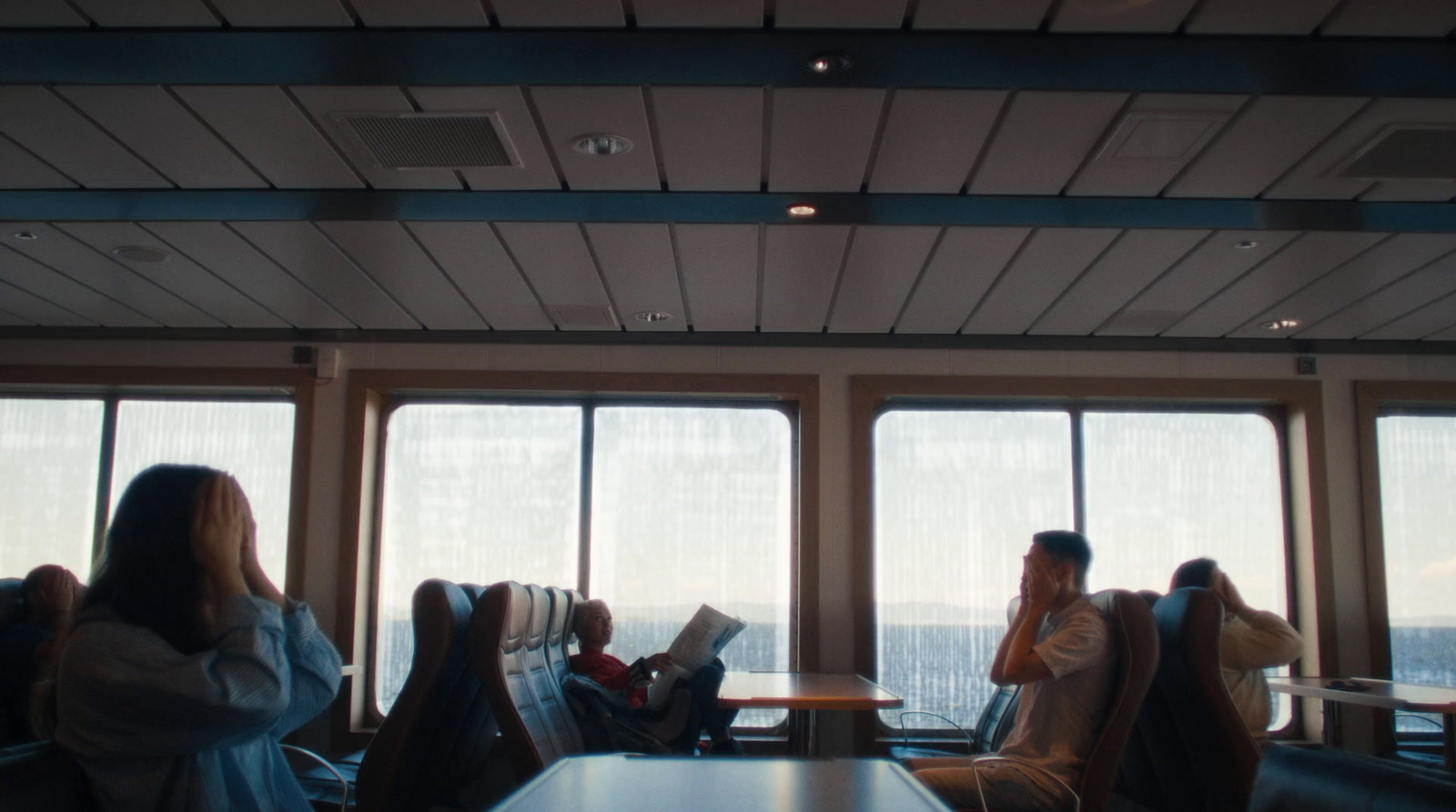 a group of people sitting at a table in front of a window