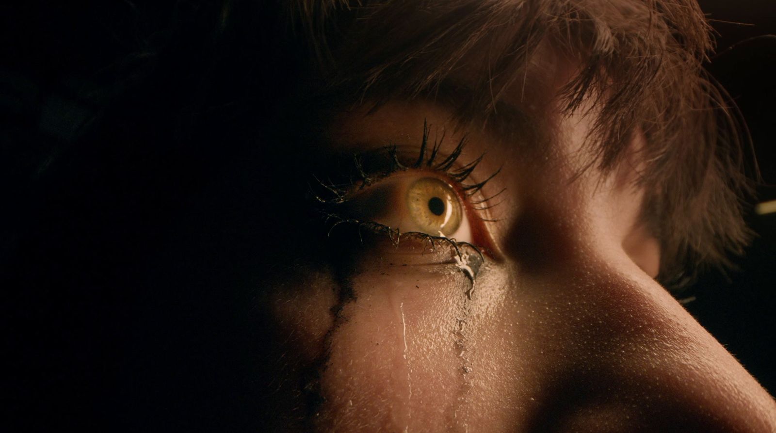 a close up of a person's eye with tears