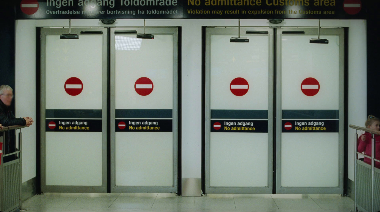 a group of people standing in front of a door