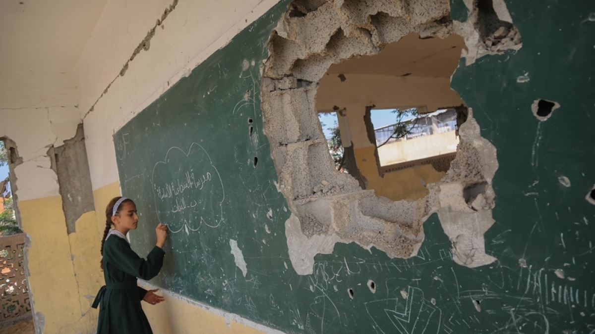 a woman writing on a wall with a hole in it