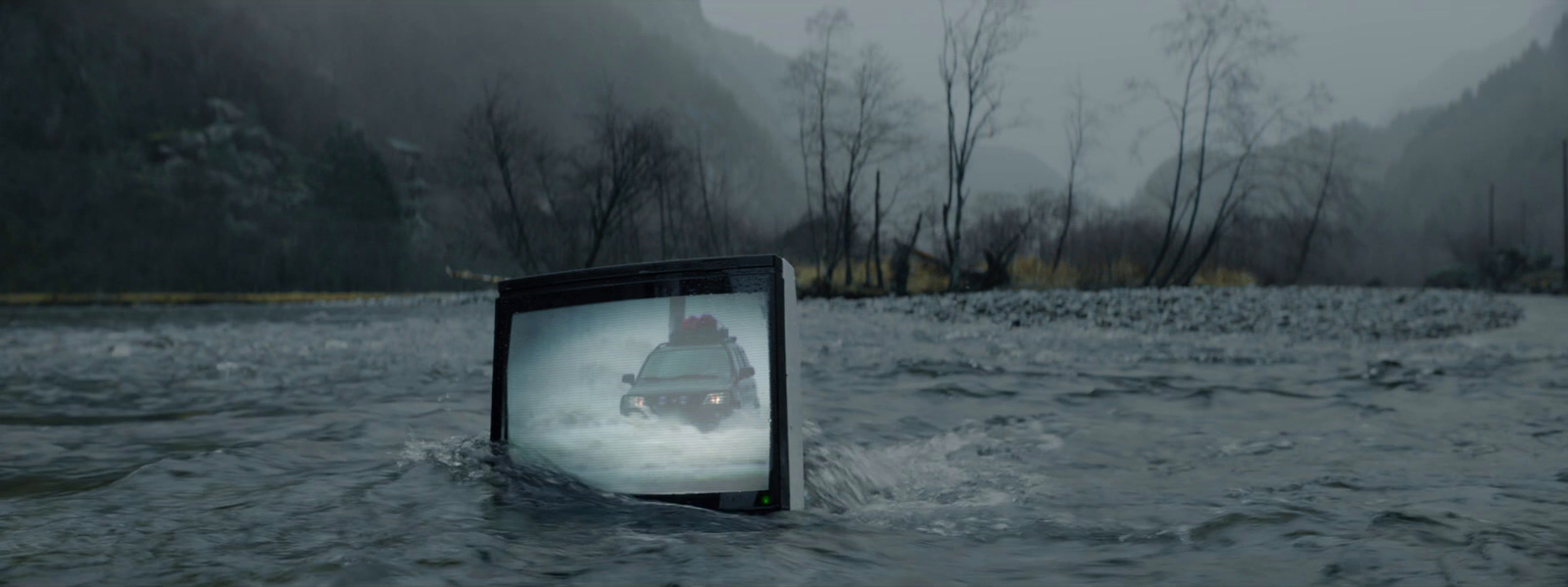 a tv sitting in the middle of a river