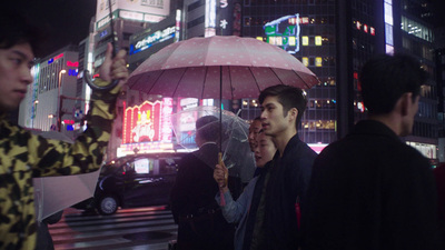 a group of people standing on a street holding umbrellas