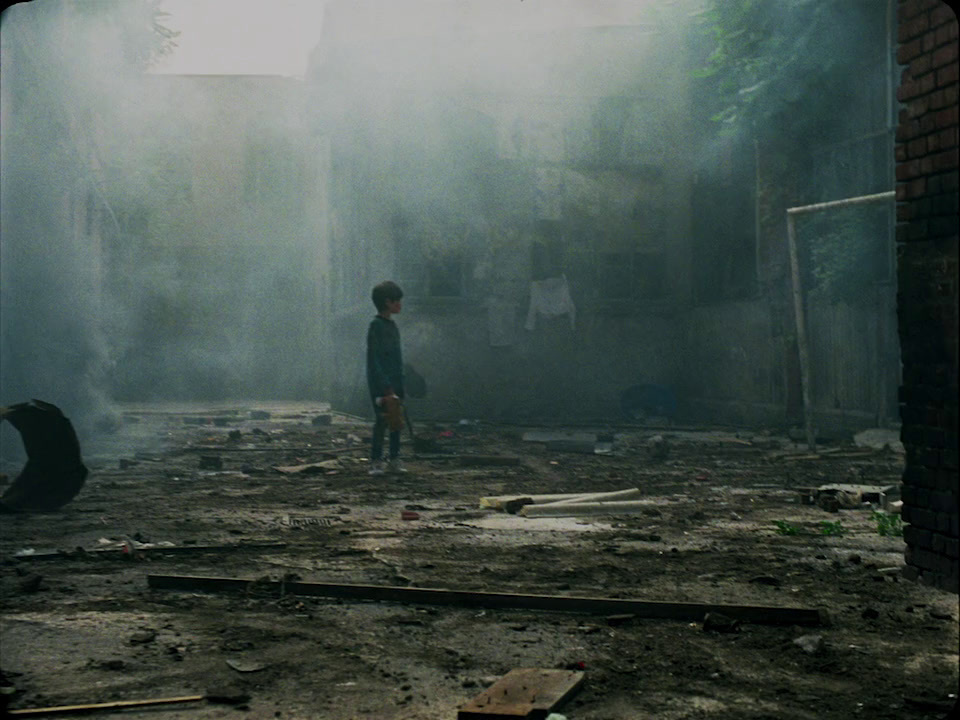 a person standing in a dirty room with a fire hydrant