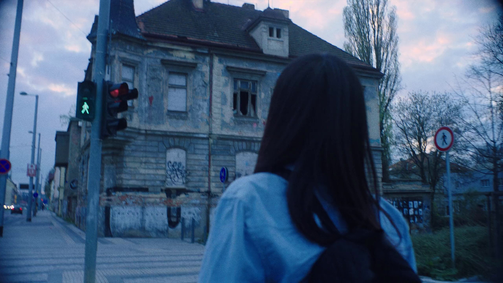 a woman standing in front of an old building