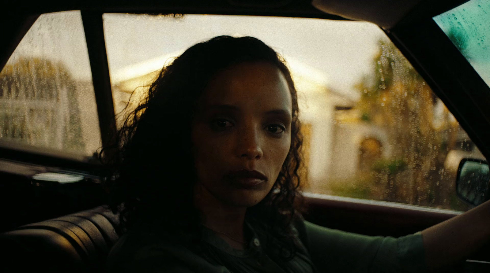 a woman driving a car in the rain