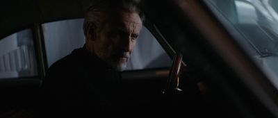 a man driving a car in the dark