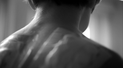 a black and white photo of a woman's back