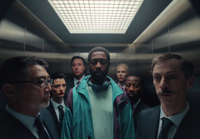 a group of men standing in a elevator