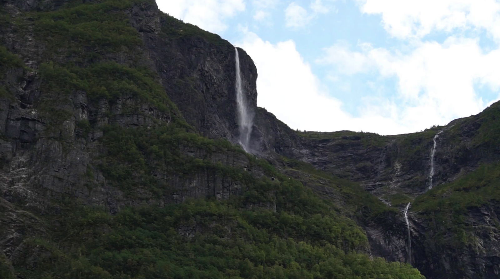 a waterfall in the middle of a mountain