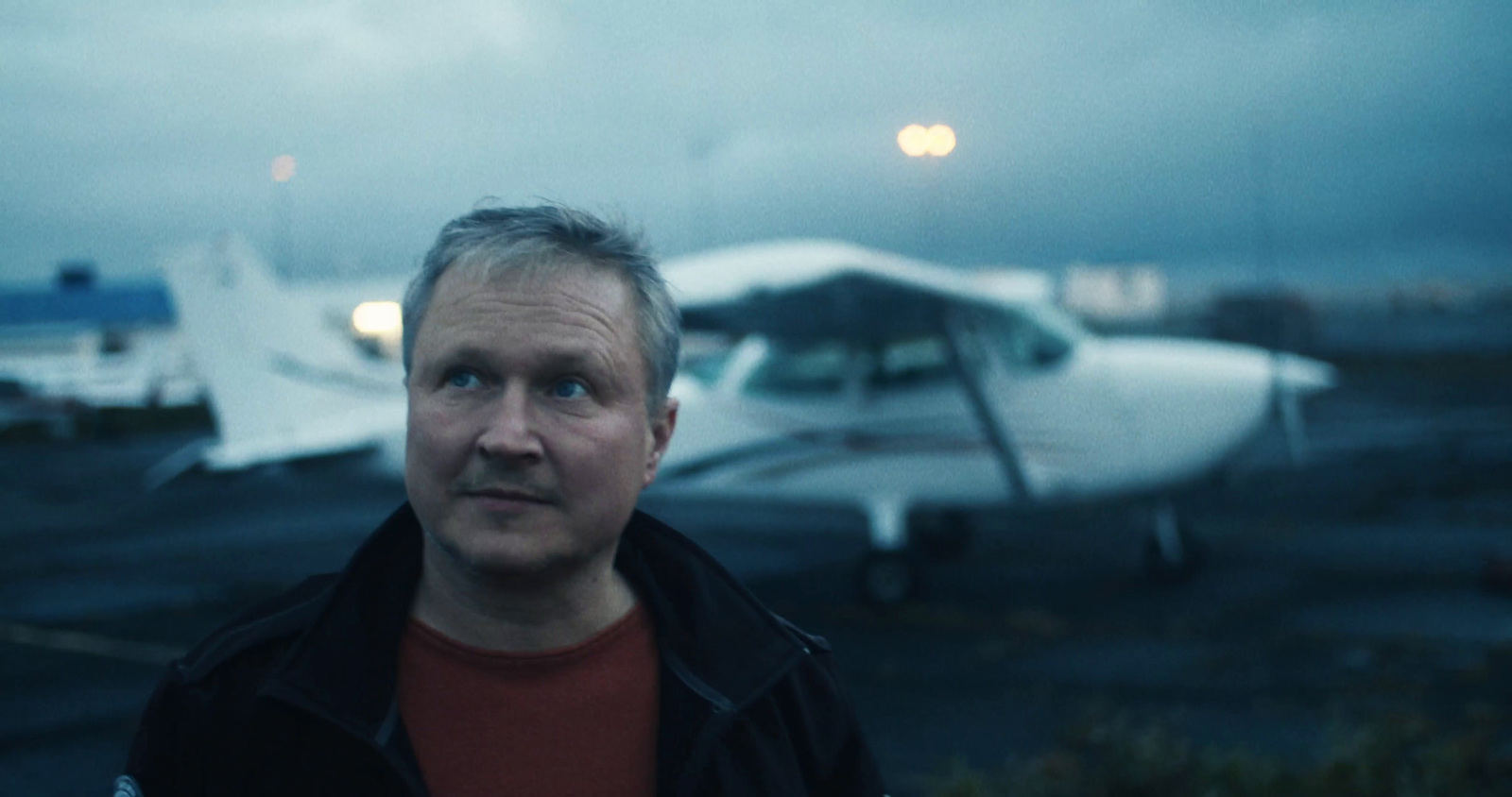 a man standing in front of an airplane