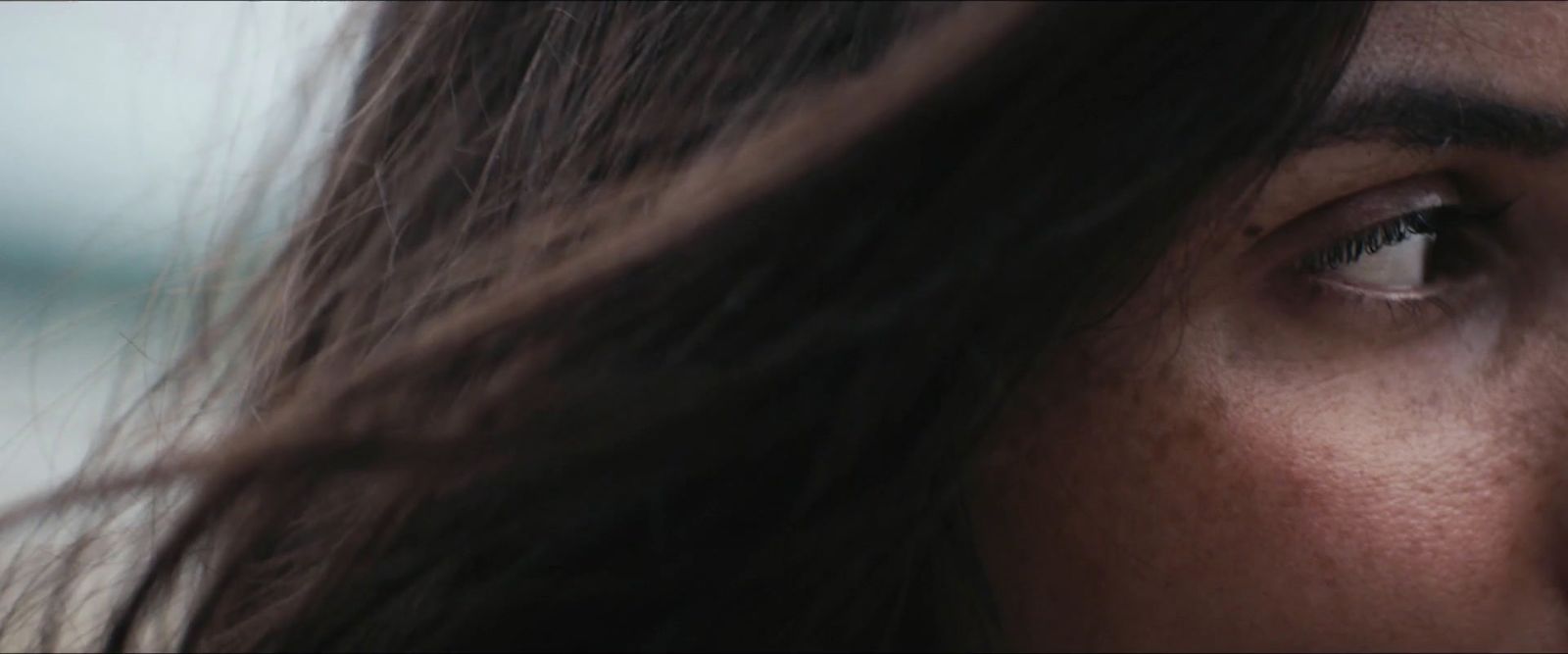 a close up of a woman's face with long hair