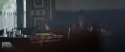 a table with a glass of water and a book on it