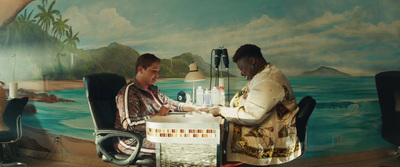 a woman sitting at a desk shaking hands with another woman