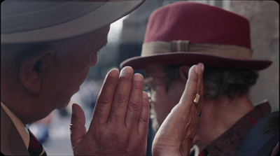 a man in a red hat and a man in a suit and tie