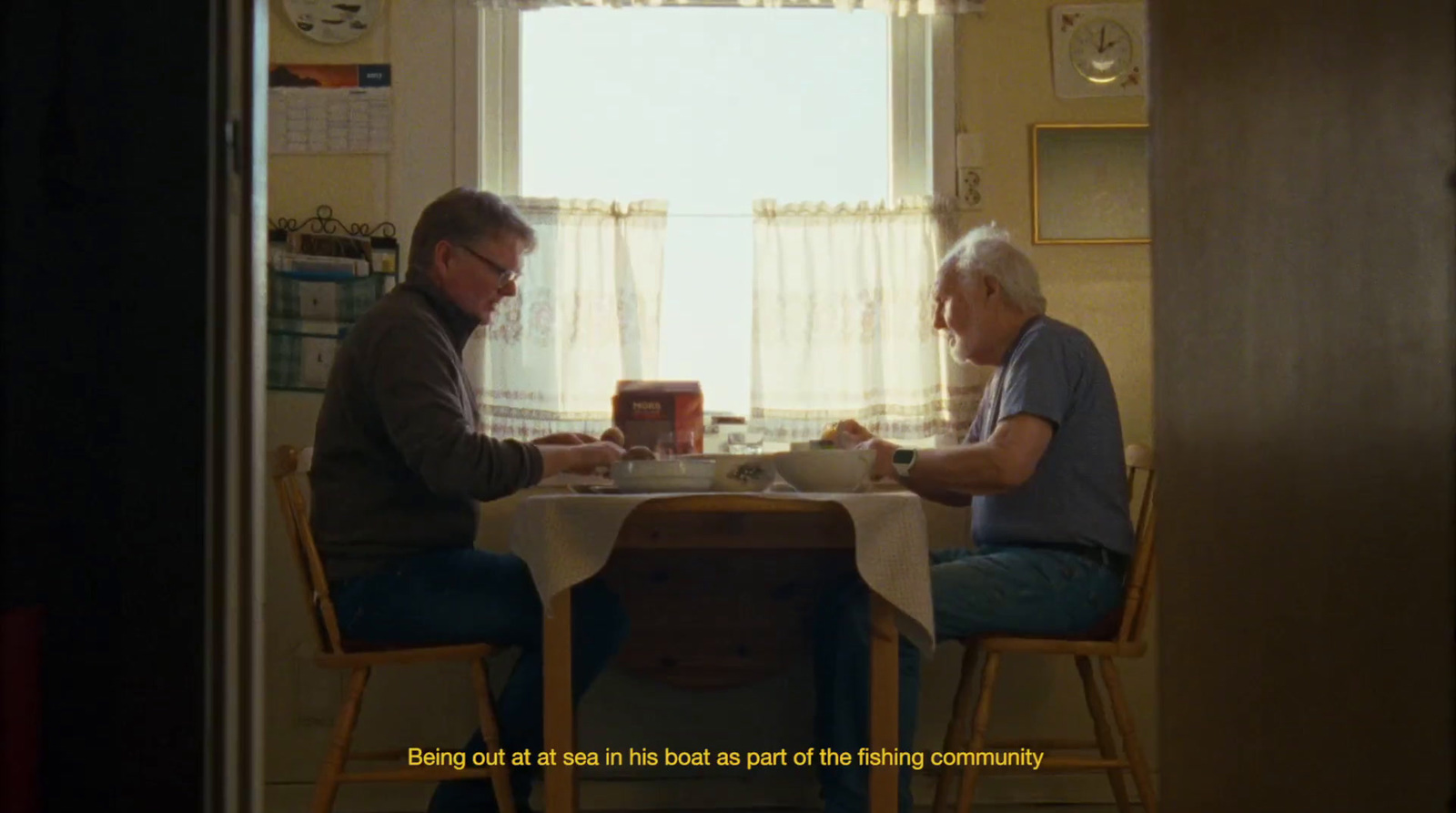 a couple of men sitting at a table