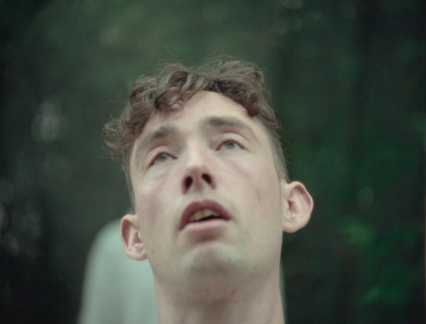 a young man looking up at something in the air