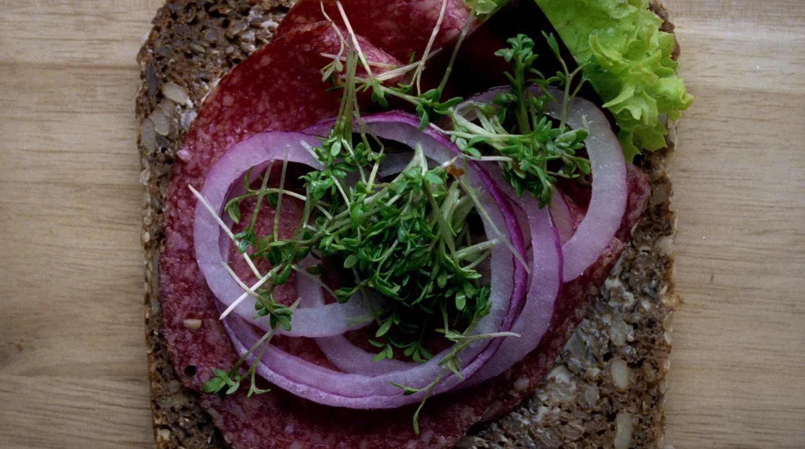 a close up of a sandwich with meat and veggies