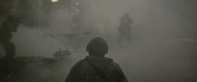 a person standing in a foggy area with a motorcycle