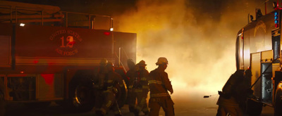 a group of firefighters standing next to a fire truck