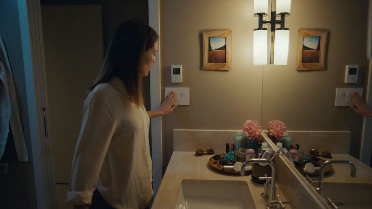 a woman standing in front of a bathroom sink