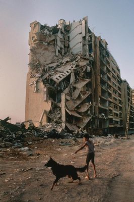 a person and a dog in front of a building