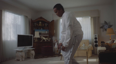 a man standing in a living room in front of a tv